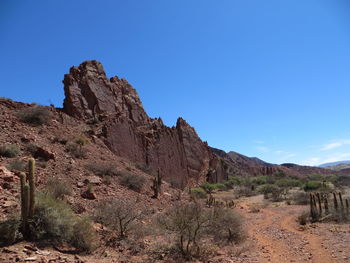 Scenic view of mountains against clear blue sky