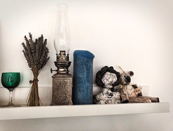 Electric lamps on table against wall at home