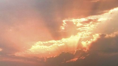 Low angle view of cloudy sky at sunset