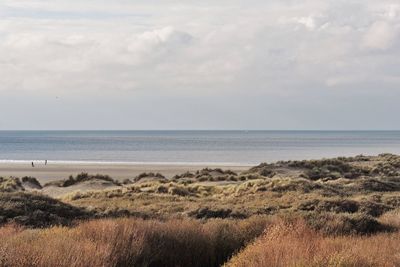 Scenic view of sea against cloudy sky