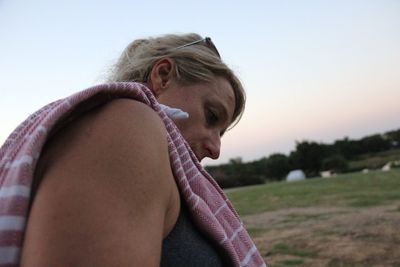 Portrait of young woman against sky