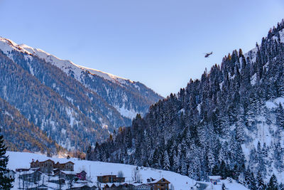 Panoramic view of snowcapped mountains against clear sky