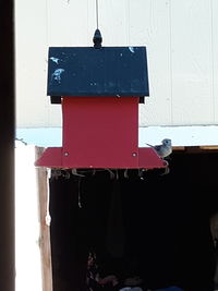 Close-up of red mailbox on wall