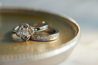 Close-up of wedding rings on table