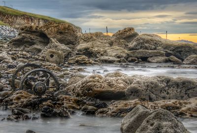 Rocks in sea against sky