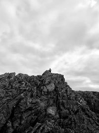 Low angle view of rock formations on mountain against sky