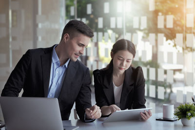 Businesswoman using laptop at office