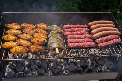 High angle view of meat on barbecue grill