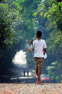 Rear view of man playing in park