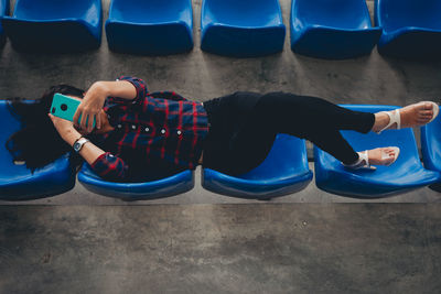 High angle view of woman relaxing on bed