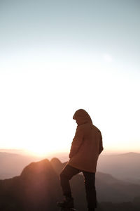 Man looking at mountains during sunrise