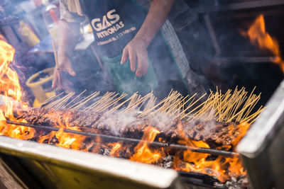Panoramic shot of meat on barbecue grill