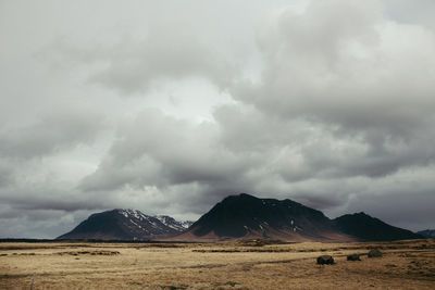 Scenic view of mountains against cloudy sky