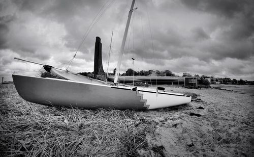 Sailboats moored on sea against sky