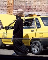 Rear view of a man standing on road