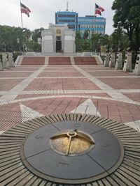 Fountain in city against sky