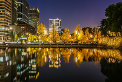 Reflection of illuminated buildings in lake at night