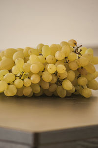 Close-up of grapes on table against white background