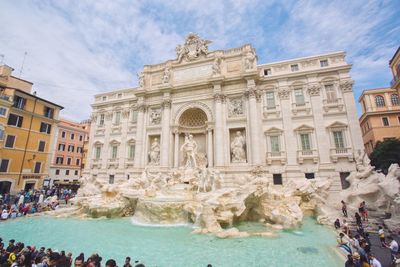 People at trevi fountain in city