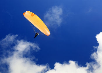 Low angle view of kite flying against blue sky