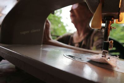 Woman sewing fabric on machine