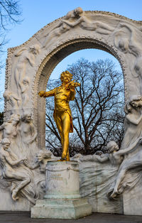 Low angle view of angel statue against sky