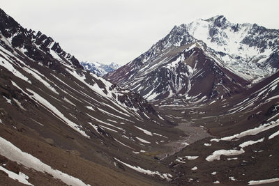 High angle view of snowcapped mountains against sky