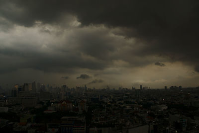 Cityscape against cloudy sky