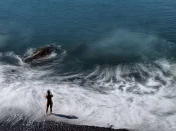 High angle view of man standing on beach