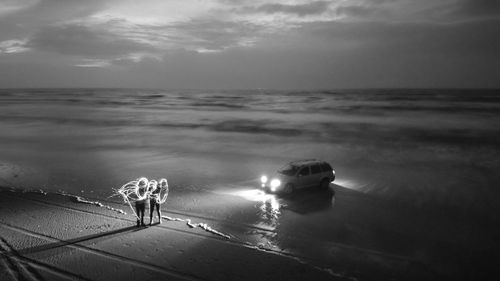 High angle view of people holding wire wool on beach