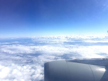 Close-up of airplane wing against sky