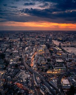 High angle view of illuminated cityscape against sky during sunset