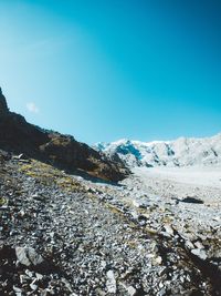 Scenic view of snowcapped mountains against clear blue sky
