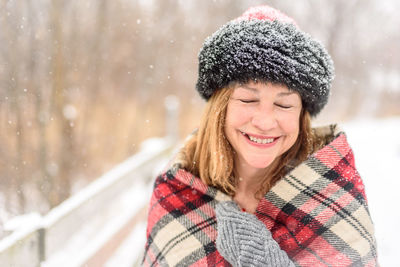 Portrait of a smiling young woman in snow