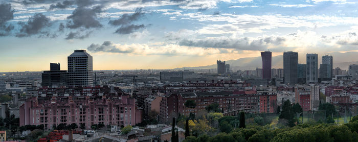 High angle view of cityscape against cloudy sky