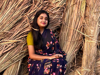 Portrait of young woman standing in farm