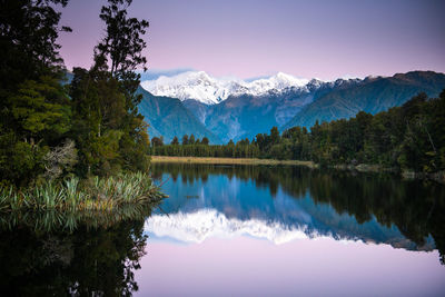 Scenic view of lake and mountains against sky