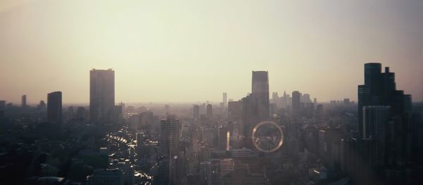 Panoramic view of city against sky during sunset