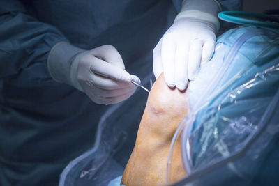 Midsection of surgeon operating patient at hospital