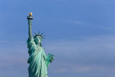 Statue of liberty against blue sky