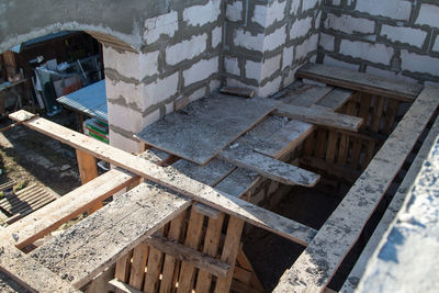 High angle view of wooden table and abandoned building