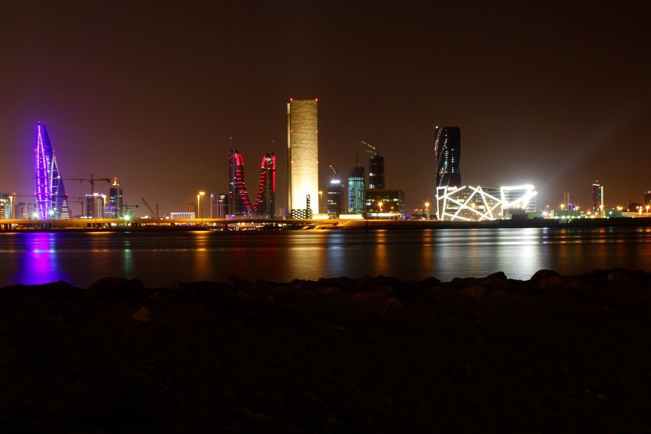 night, illuminated, architecture, built structure, city, building exterior, water, skyscraper, river, cityscape, urban skyline, sky, modern, tall - high, tower, bridge - man made structure, connection, reflection, development, capital cities