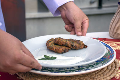 Cropped hand of person preparing food