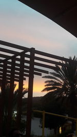Low angle view of silhouette palm trees against sky