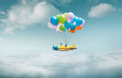 Girl riding vehicle on cloudy sky