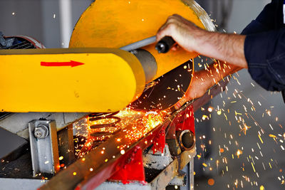 Low angle view of man working on metal