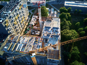 Tower crane on construction site with residential building under costruction