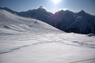 Scenic view of snow covered mountains against sky