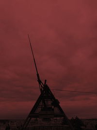 Silhouette of red crane against sky during sunset