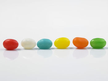 Close-up of multi colored candies against white background